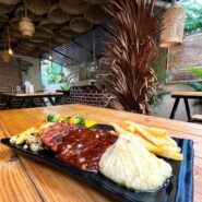 Bustling interior of Airlines Hotel showcasing outdoor dining and vintage charm