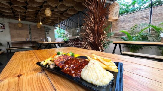 Bustling interior of Airlines Hotel showcasing outdoor dining and vintage charm