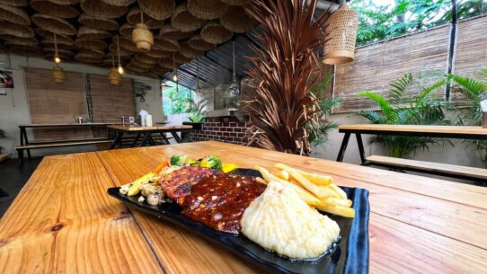 Bustling interior of Airlines Hotel showcasing outdoor dining and vintage charm
