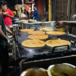 Thee small spots specialize in making crisp butter dosas in evening crowds.