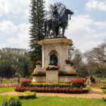 Close up view of colorful flower beds and manicured lawns in a peaceful urban park.