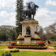 Close up view of colorful flower beds and manicured lawns in a peaceful urban park.
