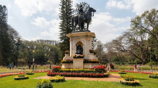Close up view of colorful flower beds and manicured lawns in a peaceful urban park.